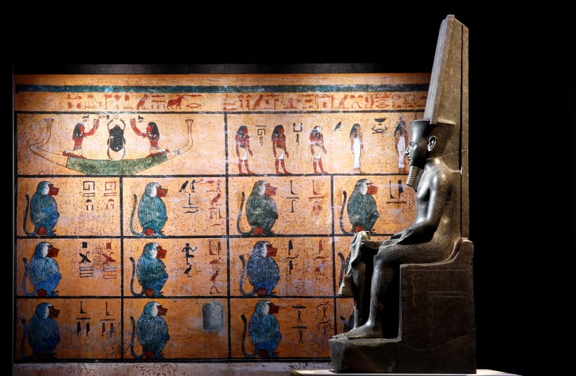 The god Amun protecting Tutankhamun is pictured during a press visit of the Tutankhamun, Treasures of the Golden Pharaoh exhibition, displaying more than 150 original artefacts, at the Grande Halle de la Villette in Paris, France, March 21, 2019. (photo credit: BENOIT TESSIER/REUTERS)