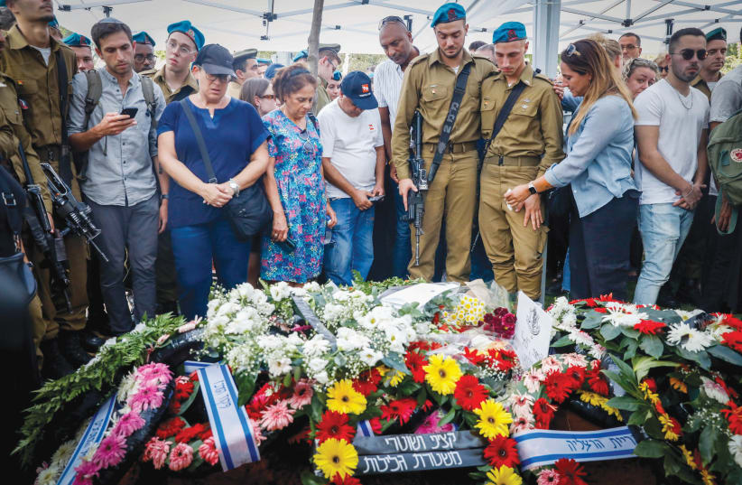  MOURNING SGT. MAXIM MOLCHANOV, killed in the Aug. 31 truck-ramming attack at Maccabim checkpoint, in Kiryat Shaul Cemetery, Sept. 5.  (photo credit: MIRIAM ALSTER/FLASH90)