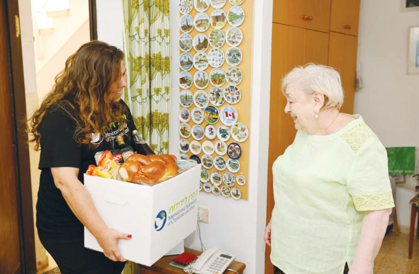  FAINA RECEIVES food and support for the holidays.  (photo credit: GUY YECHIELI)