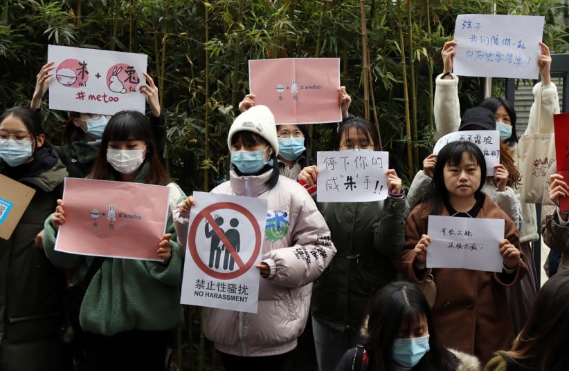  Supporters of Zhou Xiaoxuan hold signs outside a court in Beijing (photo credit: REUTERS)