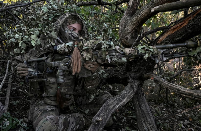  A sniper of Ukraine's 3rd Separate Assault Brigade takes a position during a reconnaissance mission, amid Russia's attack on Ukraine, near Bakhmut, Ukraine September 7, 2023. (photo credit: REUTERS/STRINGER/FILE PHOTO)