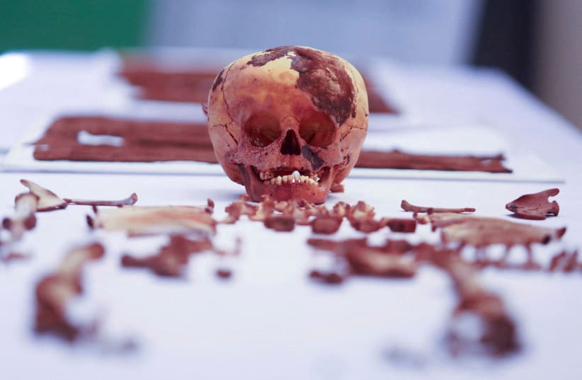  Skeletal remains of a 3-year-old infant and offerings that formed a funeral bundle with an approximate age of 1000 years found by the Calidda company during excavations to install natural gas are pictured in Lima, Peru, April 26, 2023 (photo credit: REUTERS)