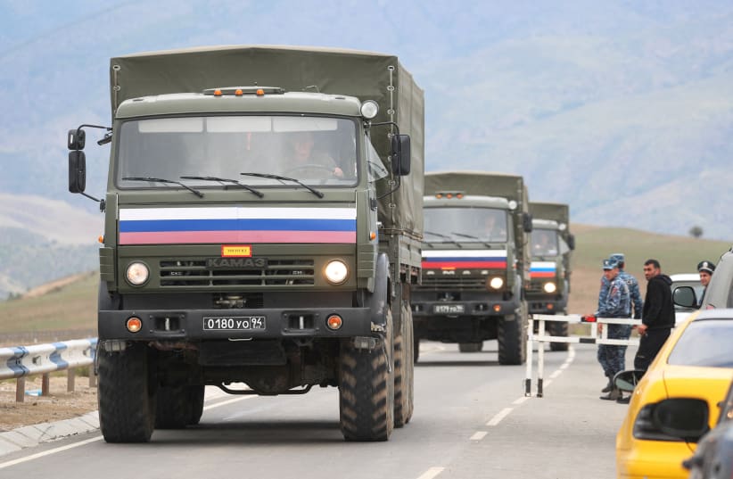  Vehicles of Russian peacekeepers leaving Azerbaijan's Nagorno-Karabakh region for Armenia pass an Armenian checkpoint on a road near the village of Kornidzor, Armenia September 22, 2023. (photo credit: REUTERS/Irakli Gedenidze/File Photo)