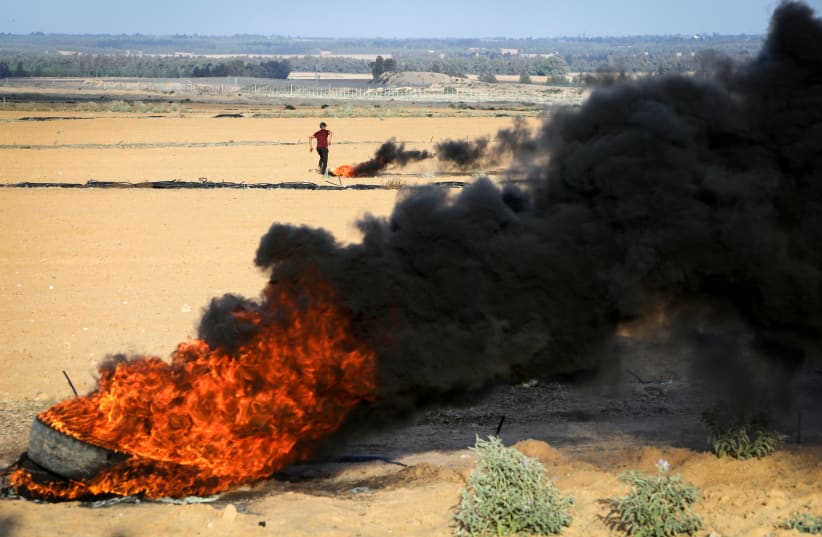 Palestinians clash with Israeli forces near the border between Israel-Gaza, in Khan Yunis in the southern Gaza Strip, on September 23, 2023 (photo credit: ABED RAHIM KHATIB/FLASH90)