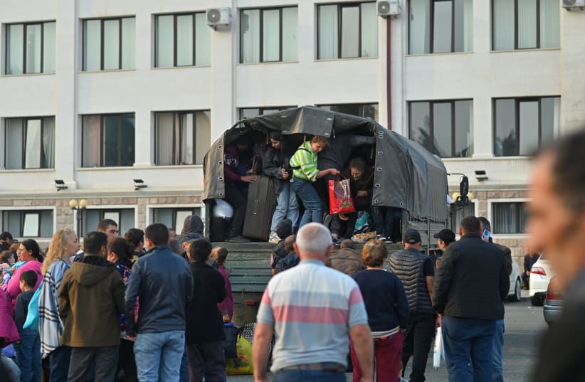  Residents board a vehicle in central Stepanakert before leaving Nagorno-Karabakh, a region inhabited by ethnic Armenians, September 25, 2023 (photo credit: REUTERS/DAVID GHAHRAMANYAN)
