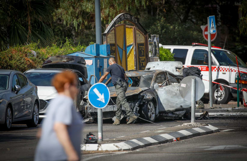  Police officers at the scene of a car explosion in Haifa, September 10, 2023 (photo credit: SHIR TOREM/FLASH90)