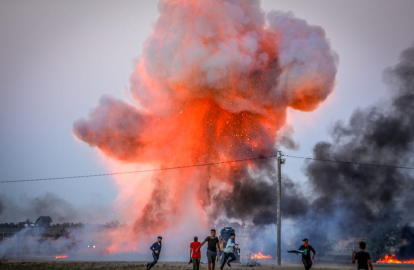  Palestinians use a large explosive device during clashes with Israeli forces near the border between Israel-Gaza, in Khan Yunis in the southern Gaza Strip. September 27, 2023. (photo credit: ABED RAHIM KHATIB/FLASH90)