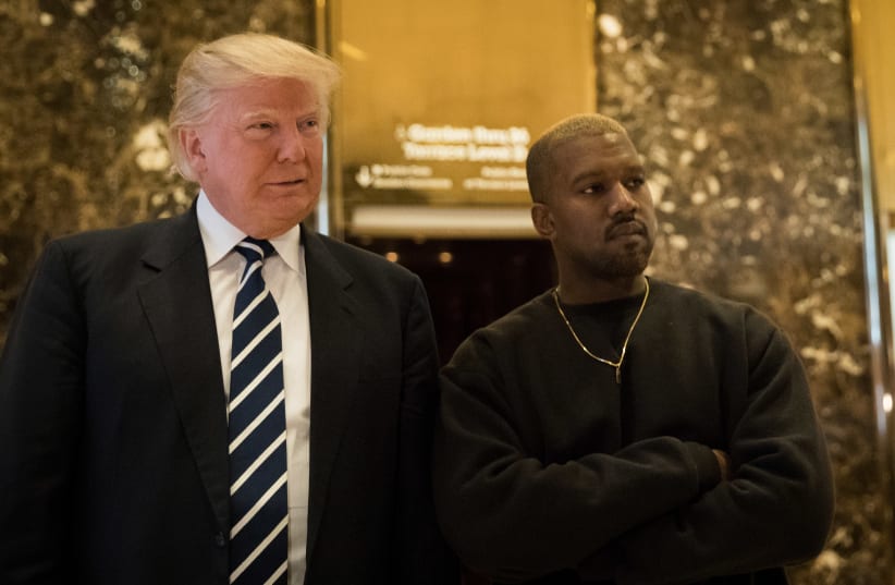   (L to R) President-elect Donald Trump and Kanye West stand together in the lobby at Trump Tower, December 13, 2016 in New York City. President-elect Donald Trump and his transition team are in the process of filling cabinet and other high level positions for the new administration. (photo credit: DREW ANGERER/GETTY IMAGES)