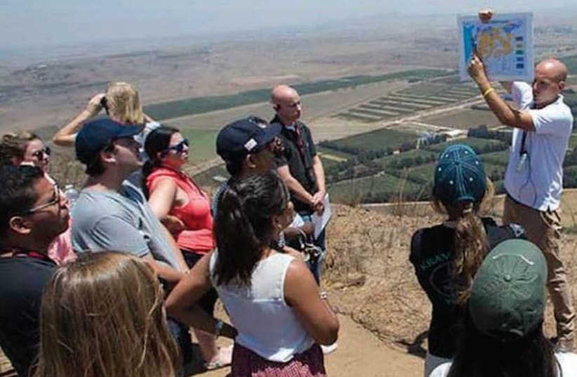  Overlooking Syria to the east, Yaakov Selavan briefs a group on the battles during the first days of the Yom Kippur War (photo credit: Shmuel Cohen/MirYam Institute)