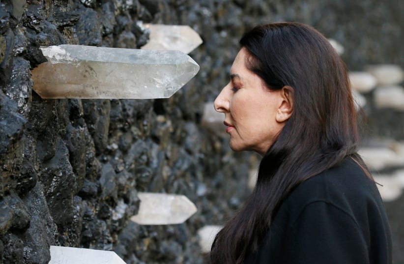  Artist Marina Abramovic performs next to her artwork "Crystal Wall of Crying" at Babyn Yar, the site of one of the biggest massacres of the Holocaust during World War Two, in Kyiv, Ukraine October 4, 2021. Picture taken October 4, 2021. (photo credit: REUTERS/GLEB GARANICH)