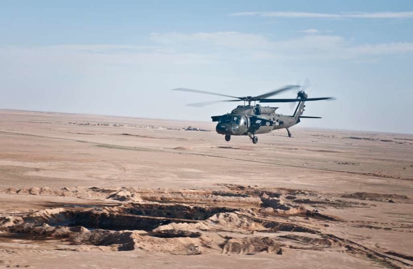  A U.S. UH-60 Black Hawk helicopter flies over the Syrian landscape, March 12, 2018.  (photo credit: PICRYL)