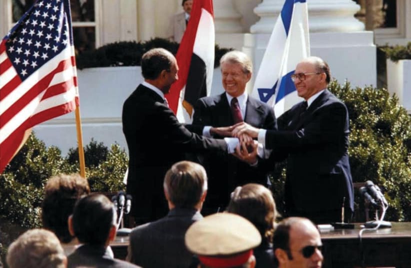  PRIME MINISTER Menachem Begin, US President Jimmy Carter, and Egyptian President Anwar Sadat join hands at the signing ceremony for the Egyptian-Israeli peace treaty, at the White House, in 1979 (photo credit: JIMMY CARTER LIBRARY/NATIONAL ARCHIVES/REUTERS)