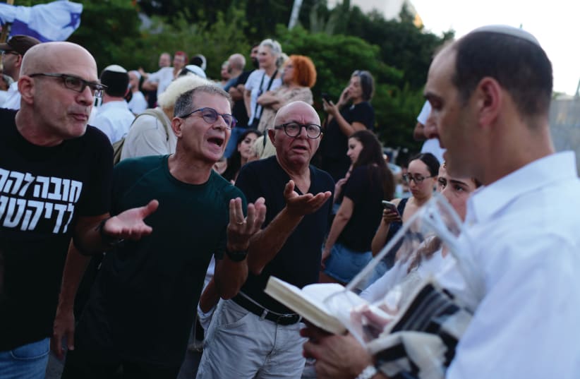  PROTESTERS CONFRONT a worshiper at Dizengoff Square in Tel Aviv, at the onset of Yom Kippur, last week (photo credit: TOMER NEUBERG/FLASH90)
