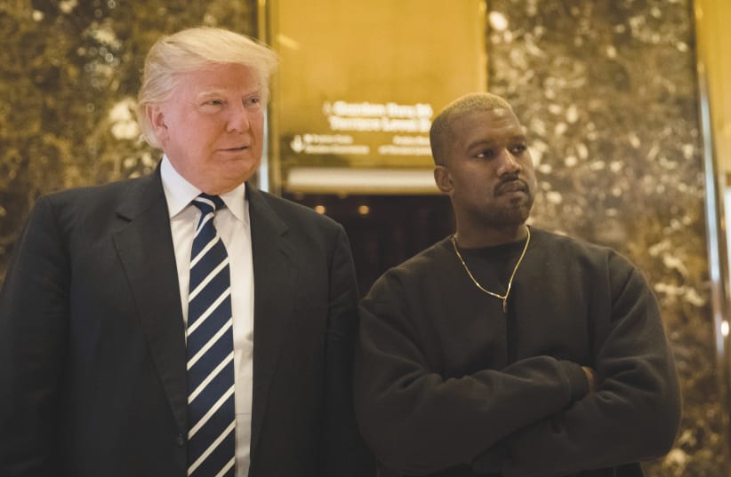  THEN-PRESIDENT-ELECT Donald Trump and Kanye West stand together in the lobby at Trump Tower, in New York City, December 2016 (photo credit: DREW ANGERER/GETTY IMAGES)
