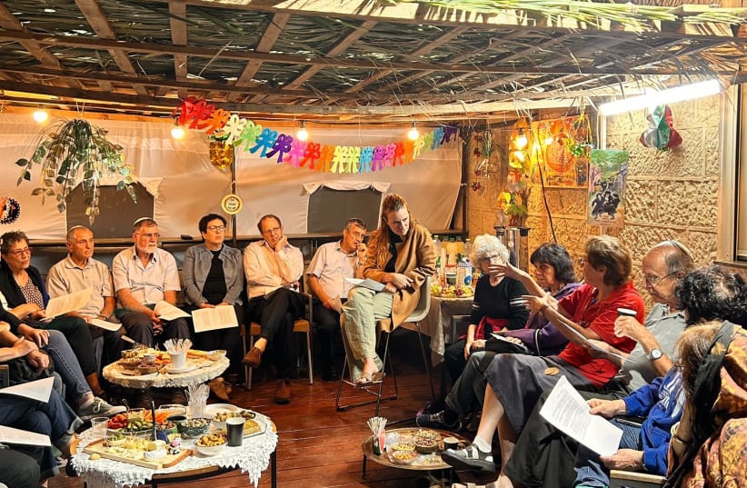 Israelis gather in a sukkah for a discussion across divides, Sunday, October 1, 2023. (photo credit: Courtesy)