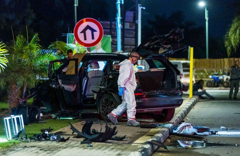  Police officers at the scene where one person was killed and two were injured in a car bomb assassination in Moshav Hatsav, October 1, 2023.  (photo credit: LIRON MOLDOVAN/FLASH 90)