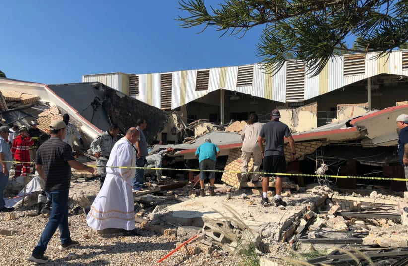  Members of security forces, people and a priest work at a site where a church roof collapsed during Sunday mass in Ciudad Madero, in Tamaulipas state, Mexico in this handout picture distributed to Reuters on October 1, 2023 (photo credit: Secretaria de Seguridad Publica Tamaulipas/Handout via REUTERS)
