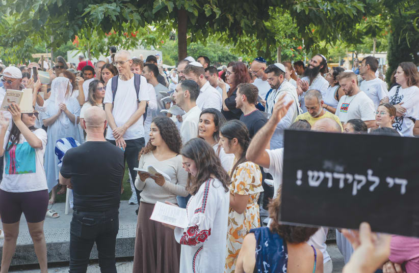 JEWS PRAY while activists protest against gender segregation in the public space during a public prayer at Dizengoff Square in Tel Aviv, on Yom Kippur last week. (photo credit: ITAI RON/FLASH90)