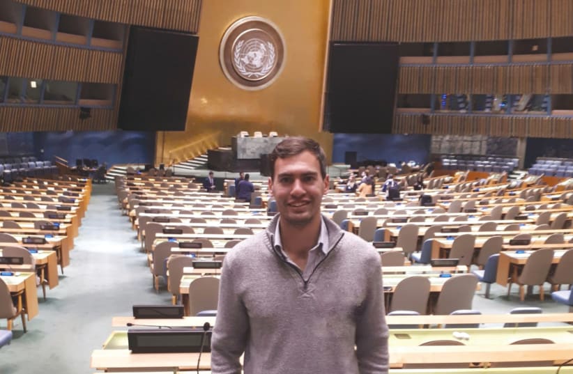  THE WRITER poses in the UN General Assembly chamber before a Model UN conference in 2018. (photo credit: AKIVA SPIEGELMAN)