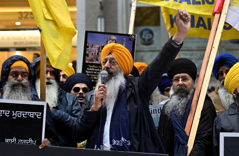  A demonstrator uses a microphone as others hold flags and signs as they protest outside India's consulate in Vancouver, British Columbia, Canada September 25, 2023. (photo credit: REUTERS)