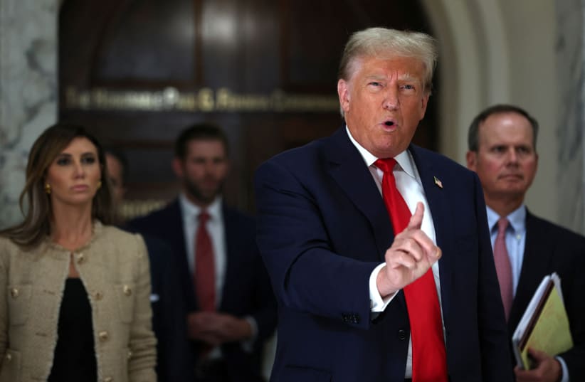  Former U.S. President Donald Trump gestures while talking to the media during a break as he attends trial in a civil fraud case brought by state Attorney General Letitia James against him, his adult sons, the Trump Organization and others in New York City, U.S., October 4, 2023. (photo credit: REUTERS/MIKE SEGAR)