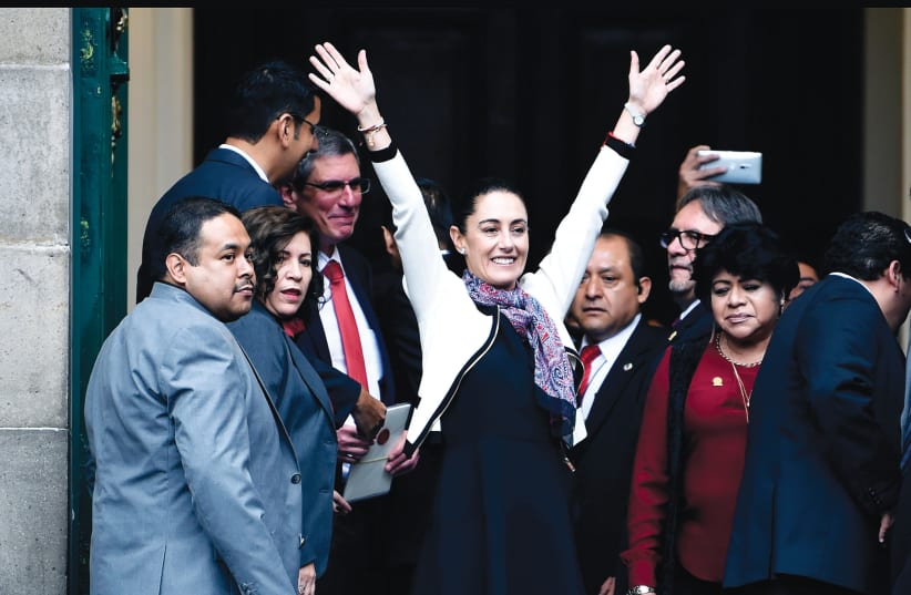  CLAUDIA SHEINBAUM – the first woman elected governor of Mexico City – waves upon her arrival to be sworn in, Dec. 2018 (photo credit: Alfredo Estrella/AFP via Getty Images)