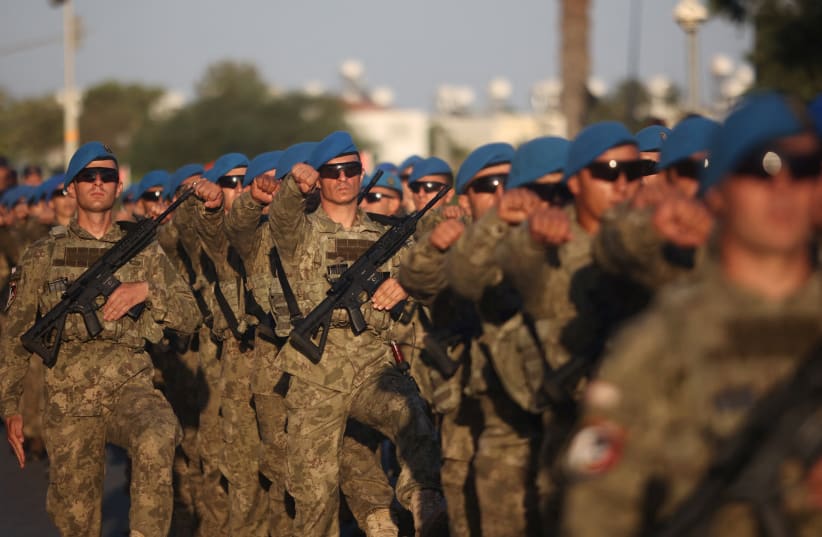  Turkish soldiers march during a military parade to mark the 1974 Turkish invasion of Cyprus in response to a short-lived Greek-inspired coup, in the Turkish-controlled northern Cyprus, in the divided city of Nicosia, Cyprus July 20, 2023. (photo credit: REUTERS/YIANNIS KOURTOGLOU)