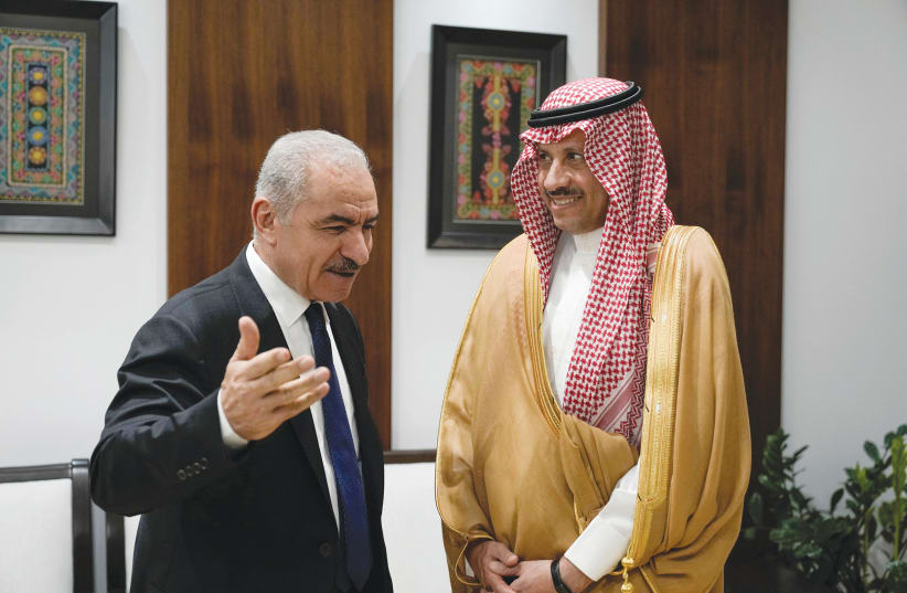  NAYEF AL-SUDAIRI, Saudi Arabia’s first-ever ambassador to the Palestinian Authority (right), listens to PA Prime Minister Mohammad Shtayyeh, during their meeting in Ramallah, last week (photo credit: MAJDI MOHAMMED/REUTERS)