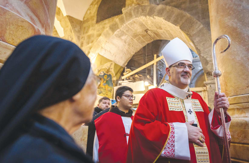  MEMBERS OF the clergy and the local Catholic community attend a mass for the late Pope Emeritus Benedict XVI, led by the Latin Patriarch Pierbattista Pizzaballa at the Church of the Holy Sepulchre, in Jerusalem’s Old City in January.  (photo credit: OLIVIER FITOUSSI/FLASH90)