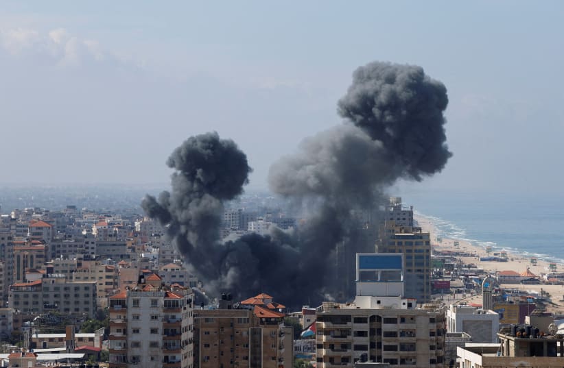  Smoke rises following Israeli strikes in Gaza, October 7, 2023.  (photo credit: REUTERS/MOHAMMED SALEM)