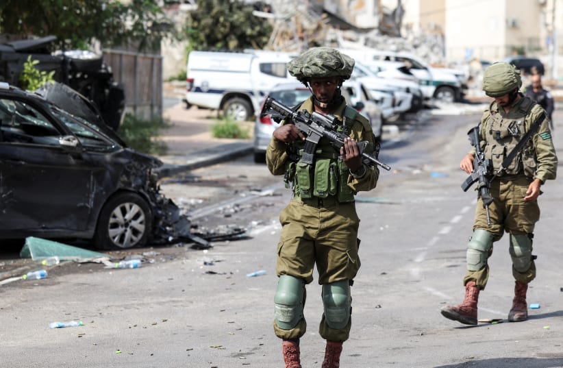  Israeli soldiers patrol near a police station following a mass infiltration by Hamas gunmen from the Gaza Strip, in Sderot (photo credit: REUTERS/Ronen Zvulun)