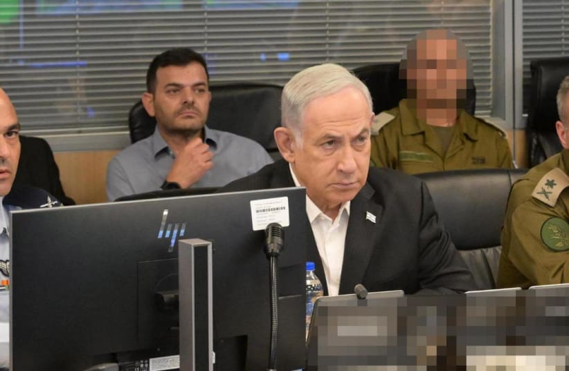   Israeli Prime Minister Benjamin Netanyahu with senior military officers in an Israeli Air Force war room, October 8, 2023. (photo credit: AMOS BEN-GERSHOM/GPO)