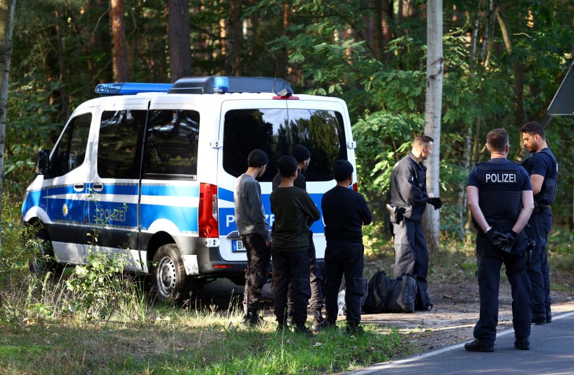 Police detain suspects as they patrol along the German-Polish border to prevent illegal migration near Klinge, Germany, September 20, 2023.  (photo credit: REUTERS/LISI NIESNER/FILE PHOTO)