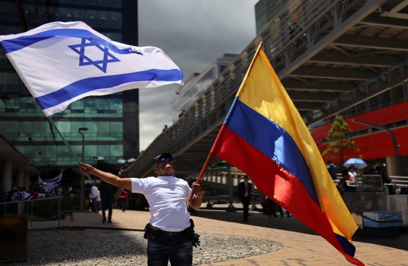  A supporter of Israel holds flags during a protest, following Hamas' biggest attack on Israel in years, in Bogota, Colombia October 9, 2023. (photo credit: REUTERS/LUISA GONZALEZ)
