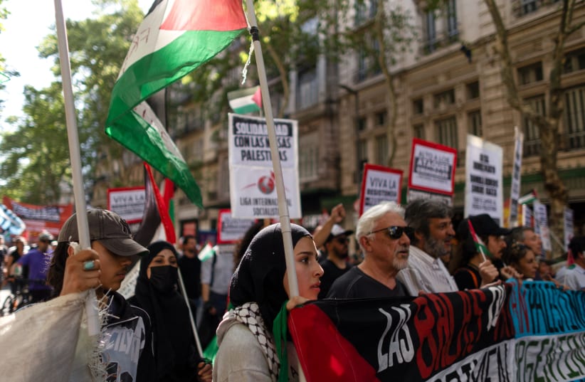  People hold a Palestinian flag and placards during a demonstration in support of Palestinians, in Buenos Aires, Argentina October 9, 2023. (photo credit: REUTERS/Tomas Cuesta)