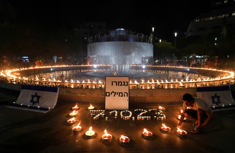  People gather and light candles to show solidarity with Israel and remember the victims following an attack by Hamas terrorists from Gaza, at Dizengoff square in Tel Aviv, Israel October 12, 2023. (photo credit: REUTERS/JANIS LAIZANS)