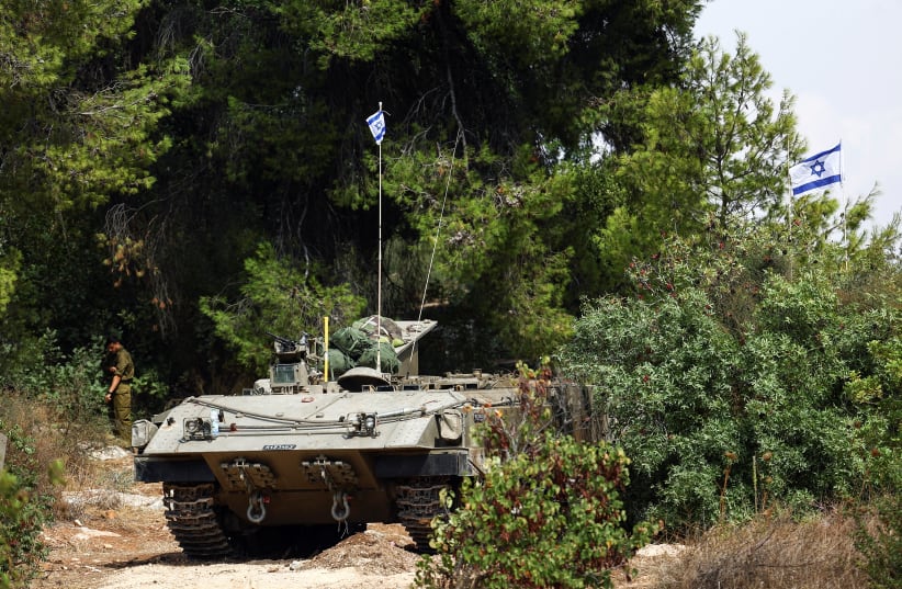  An Israeli Armored Personnel Carrier (APC) is seen at Israel's border with Lebanon as tension mounts between the countries, in northern Israel, October 11, 2023. (photo credit: Lisi Niesner/Reuters)