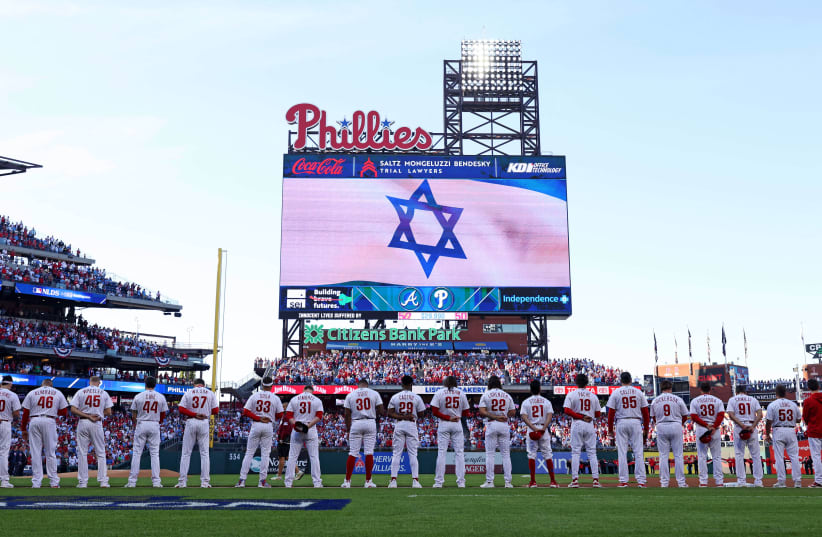  PLAYERS STAND for a moment of silence in support of Israel before Game 3 of the NLDS between the host Philadelphia Phillies and the Atlanta Braves. (photo credit: Bill Streicher/USA Today Sports)