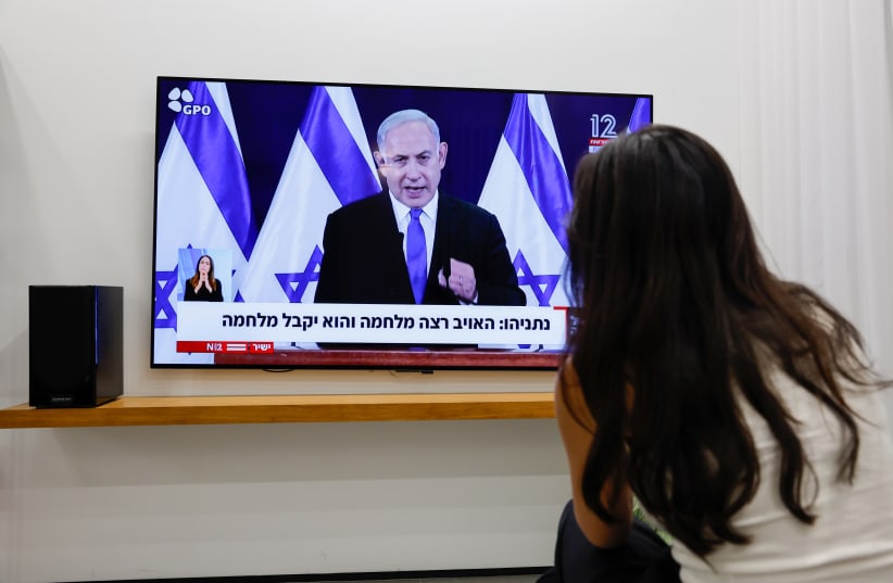  A WOMAN watches Prime Minister Benjamin Netanyahu give a statement to the public on the ongoing war, earlier this week (photo credit: NATI SHOHAT/FLASH90)