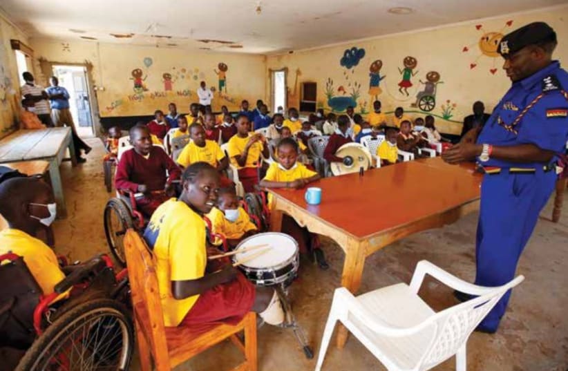  A PHYSICALLY challenged child plays the drums at the St. Lilian Special School for children, in Kenya last year.  (photo credit: MONICAH MWANGI/REUTERS)