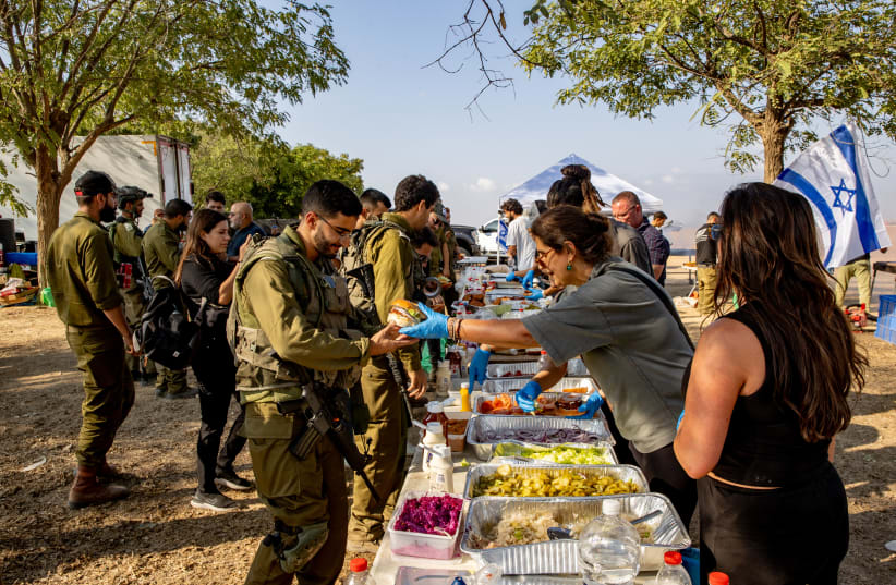  Israelis hand out food to Israeli soldiers near the border with the Gaza Strip, southern Israel, October 11, 2023 (photo credit: OREN BEN HAKOON/FLASH90)