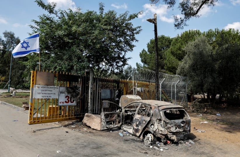  A burnt car is seen at the gate to Kibbutz Beeri, following a mass infiltration by Hamas gunmen from the Gaza Strip, in southern Israel, October 13, 2023. (photo credit: REUTERS/AMIR COHEN)