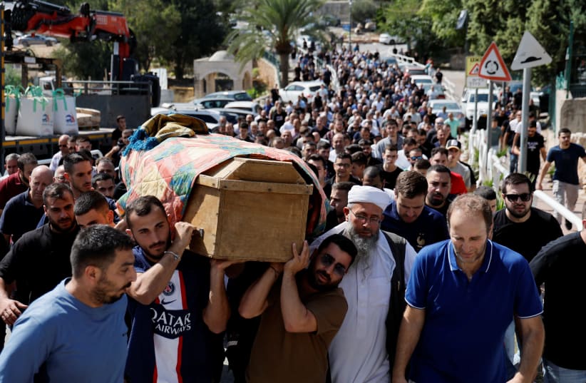  People carry a coffin, as friends and family mourn the victim of a Hamas rocket attack in the Israel-Arab village of Abu Ghosh, Israel October 14, 2023. (photo credit: REUTERS/AMMAR AWAD)