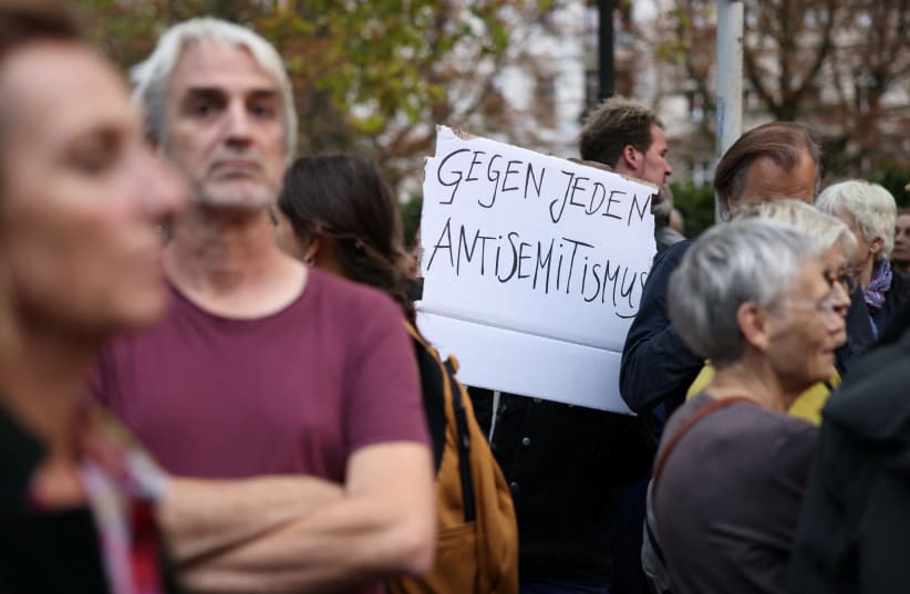  A sign reading "against all Antisemitism" is pictured during a vigil in front of the Fraenkelufer synagogue in Berlin, Germany, October 13, 2023.  (photo credit: REUTERS/Liesa Johannssen)