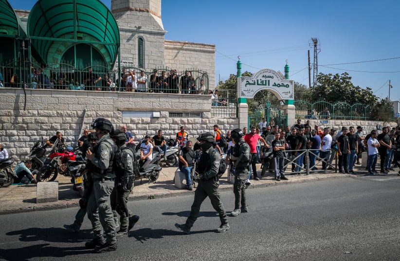 Israeli police guard while Palestinians perform Friday prayers in the East Jerusalem  Neighborhood of Ras Al Amud, October 13, 2023.  (photo credit: JAMAL AWAD/FLASH90)