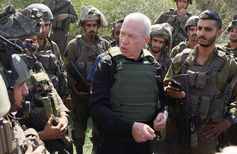 Defense Minister Yoav Gallant conducted a tour near the Gaza border and held a discussion with troops stationed in the area on October 15, 2023. (photo credit: ARIEL HERMONI/MOD)