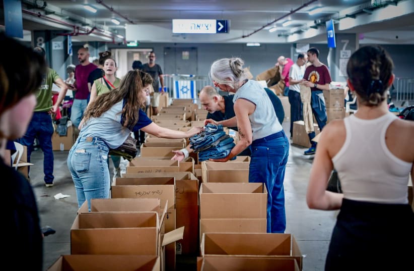  Israeli citizens pack donations of food and other necessities for the Israeli soldiers and citizens in the south, in Tel Aviv, October 15, 2023 (photo credit: AVSHALOM SASSONI/FLASH90)