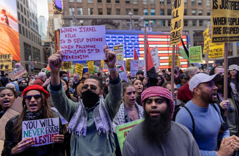  Pro-Palestinian demonstrators protest in Times Square on the second day of the ongoing conflict between Israel and the Palestinian militant group Hamas, in Manhattan in New York City, U.S., October 8, 2023 (photo credit: JEENAH MOON/REUTERS)
