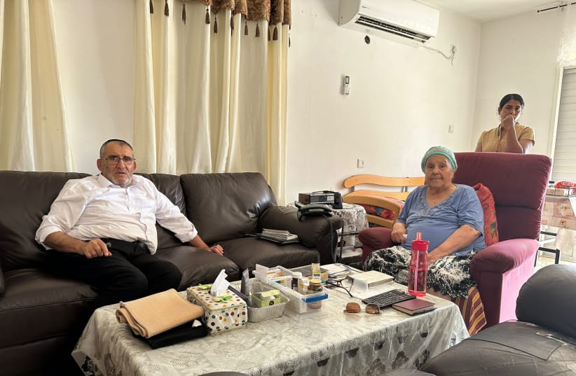 Emilia Marcel-Sofer (C), with her son-in-law (L) and live-in aid, Rajie Rajan, in her home in Ramla, Israel, Oct. 12, 2023.  (photo credit: DARIO SANCHEZ/THE MEDIA LINE)