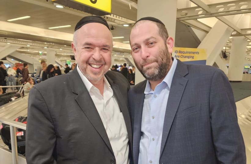  THE WRITER (right) and Yaakov Serle, himself evacuated, are at JFK Airport in New York, greeting individuals returning to the US. (photo credit: Yaakov Serle)